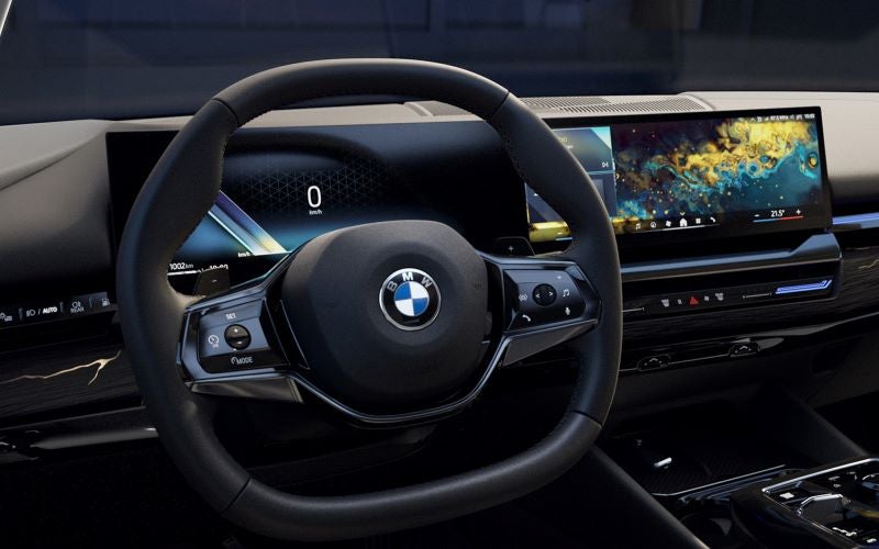 5 series interior with steering wheel and curved display..