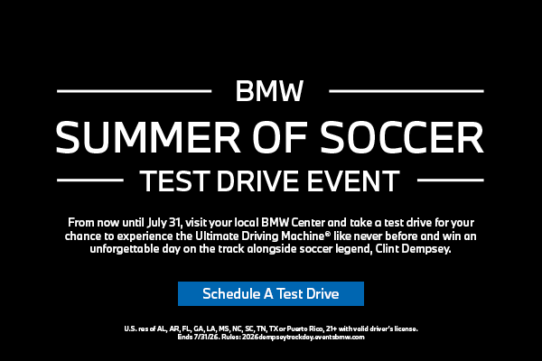 Clint Dempsey standing in front of the BMW X3, X5, & 3 Series on a test track.