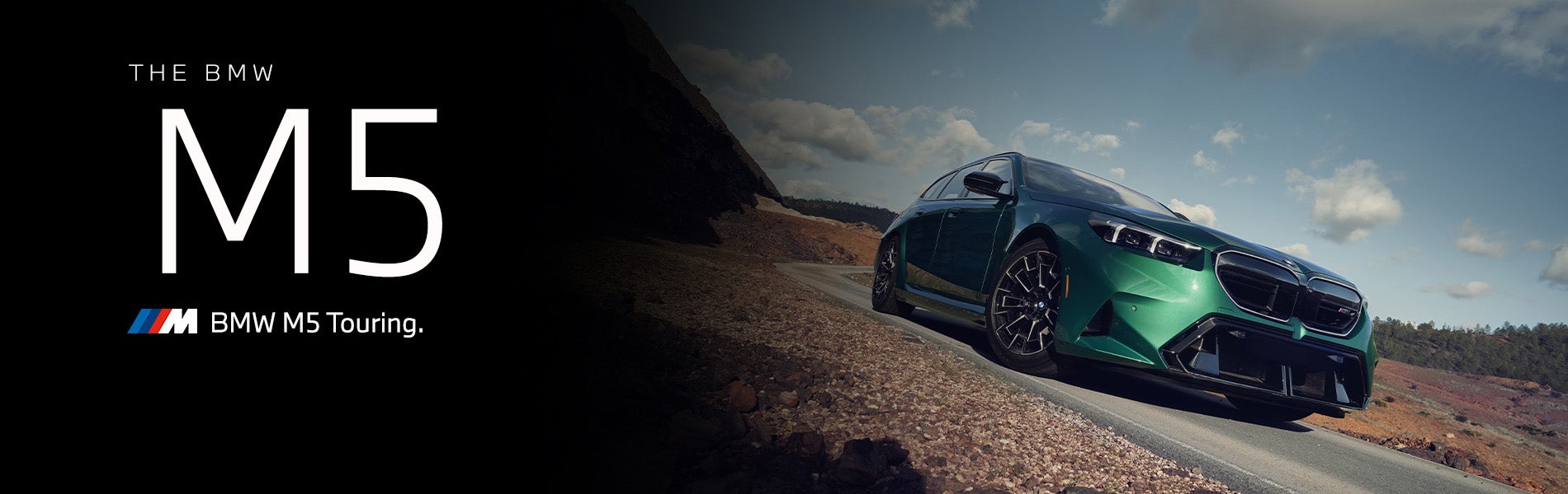 The new BMW M5 Touring in green driving down desert road | Taylor BMW in Evans GA