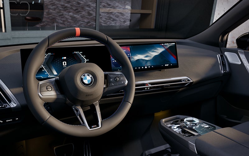 Interior steering wheel and dashboard of the BMW iX M70. | Taylor BMW in Evans GA