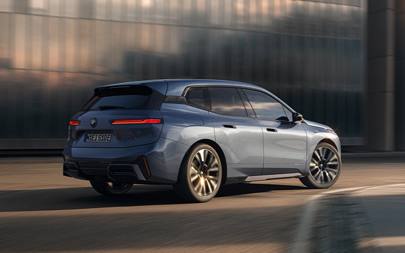 The BMW iX driving with the front wheel turned. | Taylor BMW in Evans GA